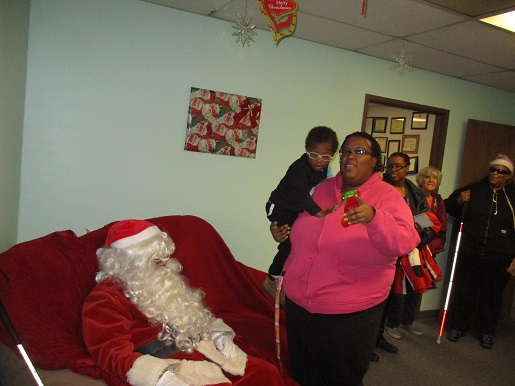 A mother and her son coming in to see Blind Santa